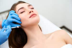 Woman getting facial fat grafting injections in Calgary AB