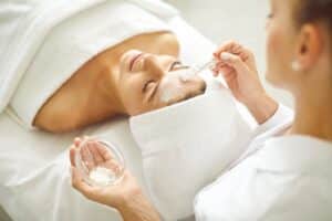 Relaxed woman getting a facial in Calgary, AB